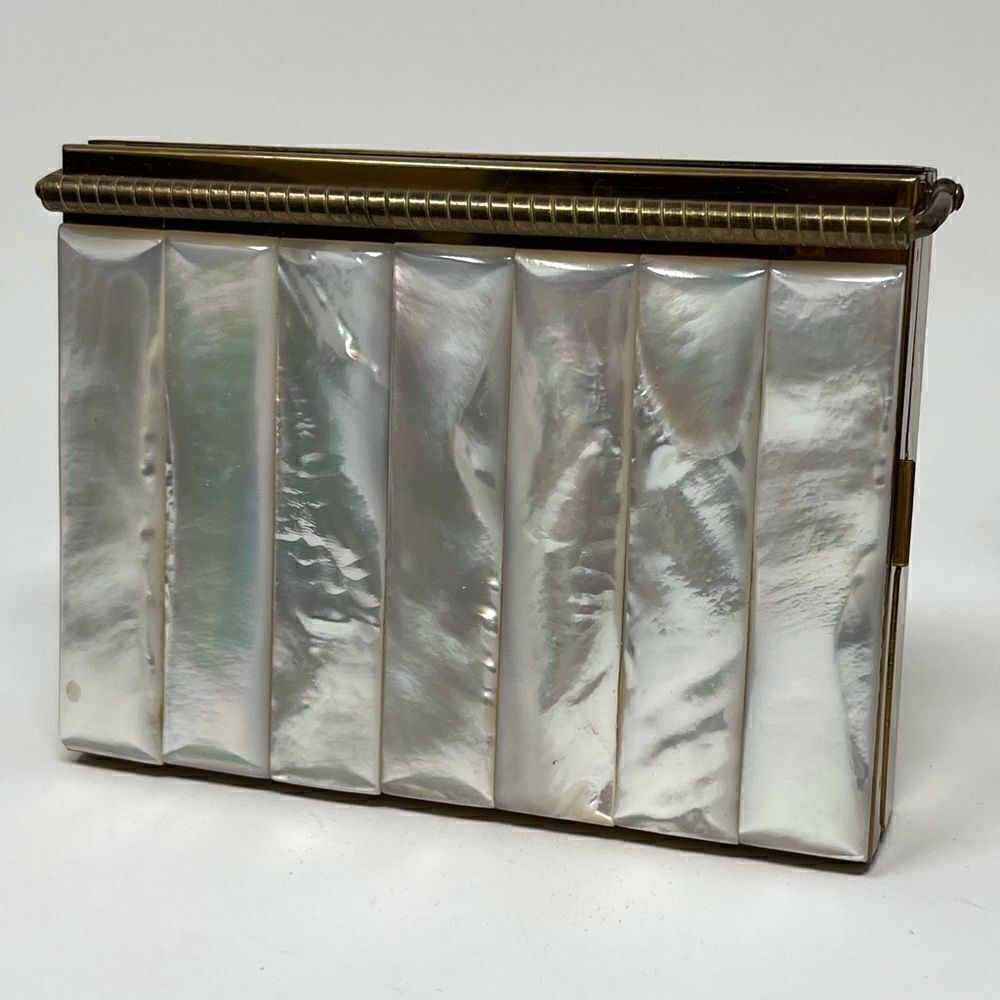 Volupte vintage MOP compact with multi compartments and original comb.